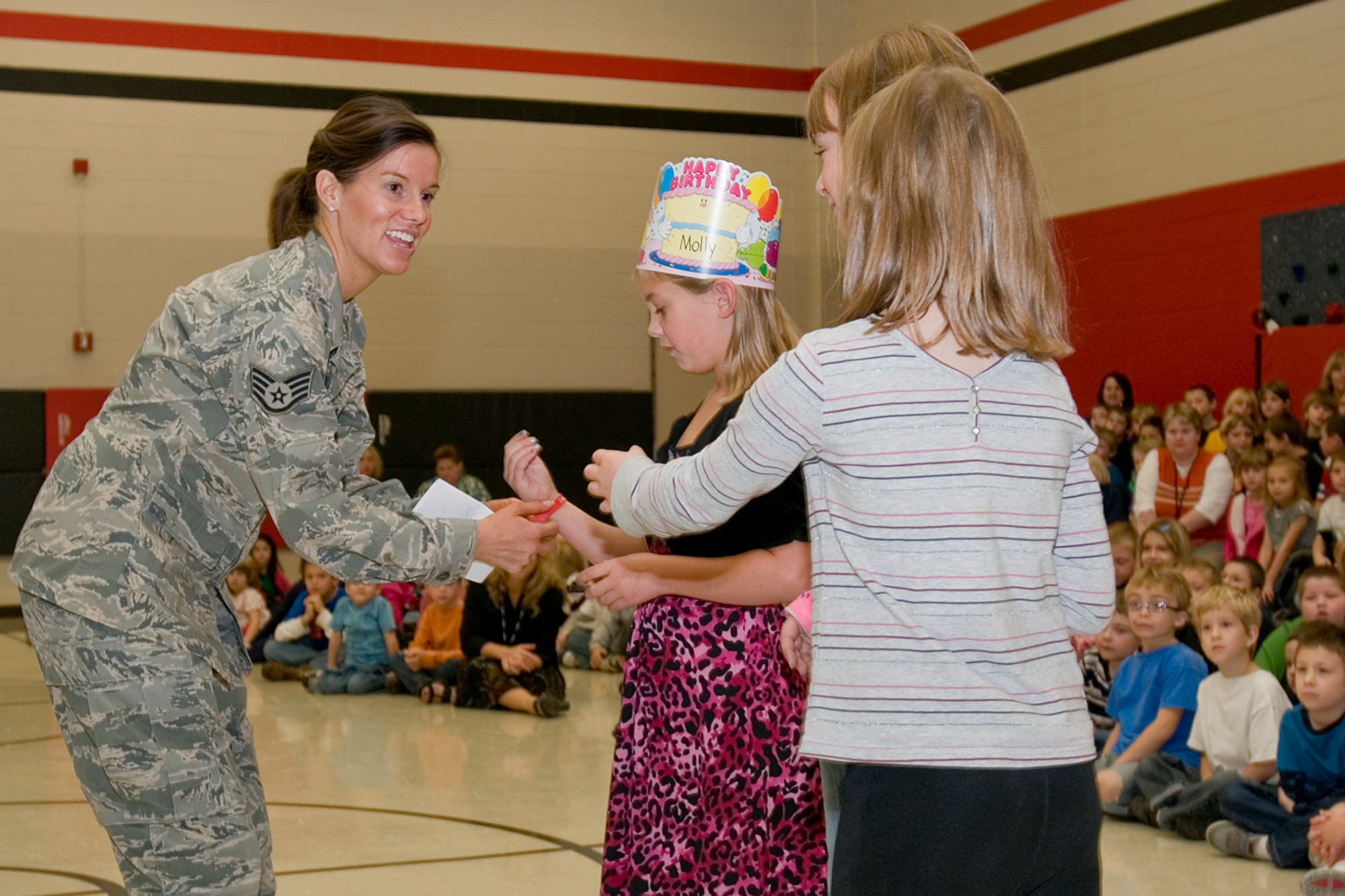 GRISSOM AIR RESERVE BASE, Ind. -- Staff Sgt. Lisette Pittman, 434th Aerospace Medicine Squadron health service technician, places an anti-drug bracelet around a student from North Miami Elementary, Denver, Ind., during a Red Ribbon Week presentation at the school Oct. 25. Red Ribbon Week is the nation's largest and oldest drug prevention program. It reaches millions of Americans during the last week of October every year. (U.S. Air Force photo/Senior Airman Damon Kasberg)