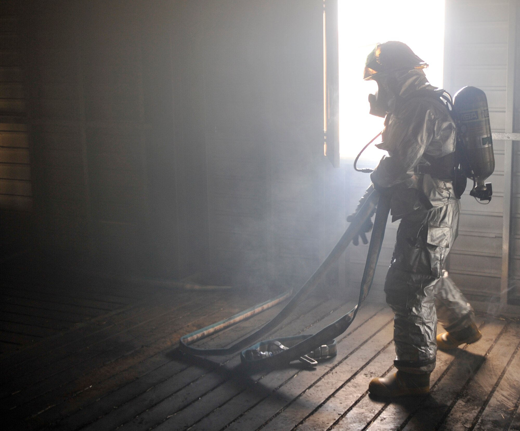 Airman Darby Parker, 19th Civil Engineer Squadron firefighter, unravels a fire hose Oct. 28, during a building clearing and structural fire training scenario. The training firefighters receive consists of confined space, auto extracation, aircraft mishaps, and wild land fires, and is designed to test their mission-ready capabilities. (U.S. Air Force photo by Senior Airman Caleb Pierce)