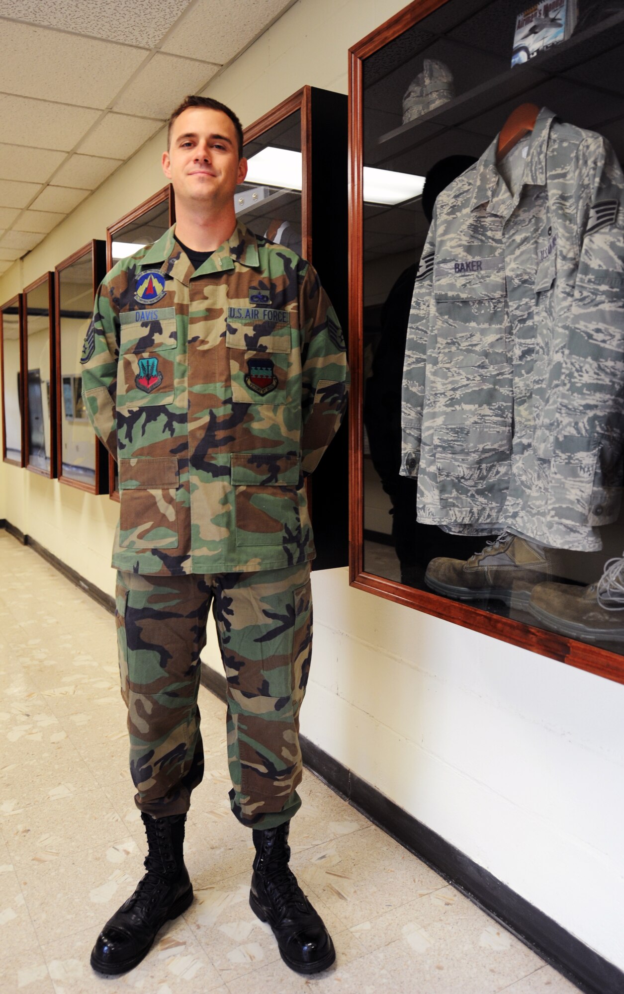 U.S. Air Force Staff Sgt. Joshua Davis, 372nd Training Squadron F-16 Fighting Falcon engines instructor, stands next to uniform cases in the Hallingquest Hallway in the 372nd TRS that he and Staff Sgt. Mitchell Baker put together, 372nd TRS outside the gates of Shaw Air Force Base, S.C., Oct. 31, 2011. Together, Davis and Baker contributed about 360 hours in about three to four months to complete the uniform cases. (U.S. Air Force photo by Airman 1st Class Tabatha Duarte/Released)