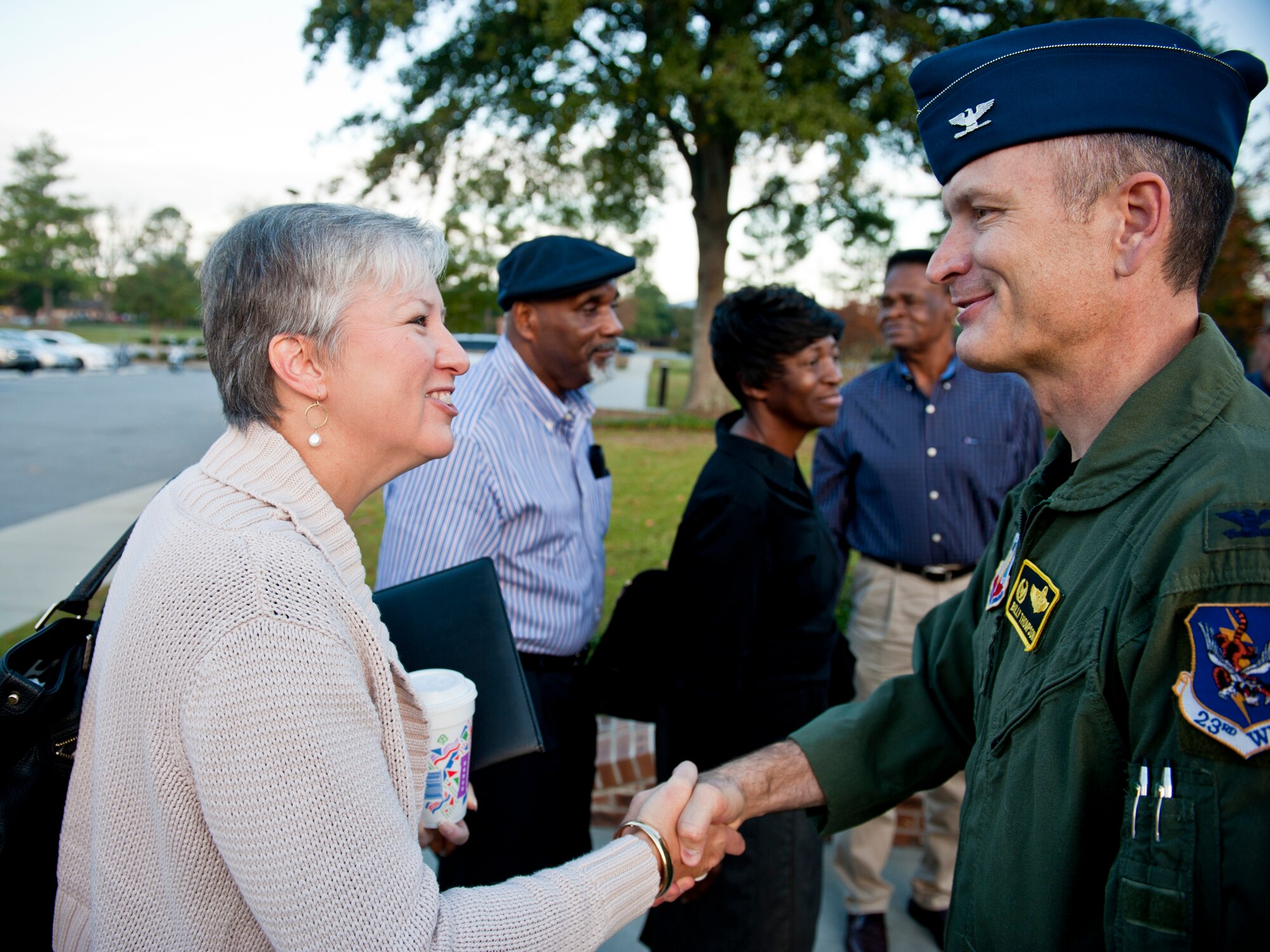 U.S. Air Force Col. Billy Thompson, 23rd Wing commander, shakes hands with Mara Register, Valdosta city manager representative, during a visit from local city and county officials at Moody Air Force Base, Ga., Oct. 28, 2011. October was National Community Planning Month, a month dedicated to the important role of planning in communities across the U.S. During the visit, base and county officials discussed their plans to improve the community and what they could do to become a stronger team. The visitors also saw some of Moody’s capabilities through a tour where they met with various Airmen and agencies. (U.S. Air Force photo by Staff Sgt. Jamal D. Sutter/Released)