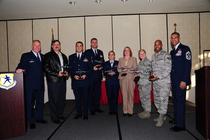 Col. Erik Hansen (left) and Chief Master Sgt. Terrence Greene recognize Mark Gardner, Master Sgt. Jamey Elms, Capt. Nicholas Lee, 2nd Lt. Whitney Hayes, Rhonda Perry, Staff Sgt. Courtney Rush and Senior Airman Marquis Jones as the 3rd Quarter Award winners during a ceremony at the Charleston Club Nov. 1. Hansen is the 437th Airlift Wing commander, Greene is the 437th AW command chief, Gardner is from the 437th Aircraft Maintenance Squadron, Elms is from the 437th Maintenance Squadron, Lee, Hayes and Perry are from the 437th Aerial Port Squadron, Rush is from the 437th AMXS and Jones is from the Operations Support Squadron. (U.S. Air Force photo/ Tech. Sgt Chrissy Best)
