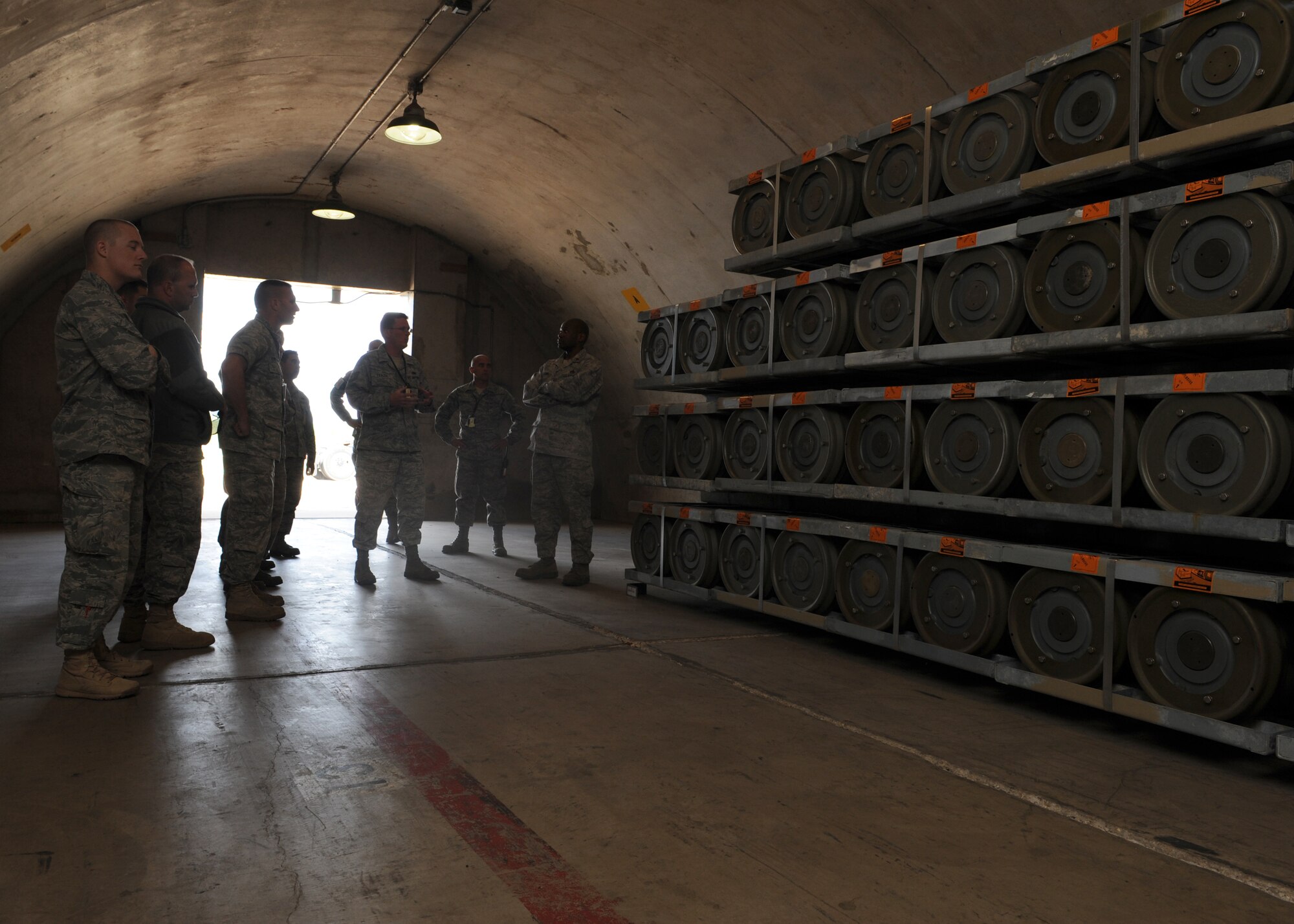 Tech. Sgt. Robert Feazel, 7th Munitions Squadron, center, explains to a tour group the housing requirements for bombs Oct. 28, 2011, at Dyess Air Force Base, Texas. The tour consisted of an inside look of Dyess’ bomb shelters, the recycling of old bomb facilities and the repair of rotary launchers located inside of the B-1 Bomber. (U.S. Air Force photo by Airman 1st Class Jonathan Stefanko/ Released)