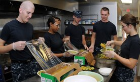Sailors from Naval Nuclear Power Training Command prepare food at the Joint Base Charleston-Air Base Child Development Center. The Sailors go to the JB Charleston – Air Base CDC Monday through Friday and help cook, prepare and distribute meals for all the children while they wait on their orders to their next school assignment. (U.S. Navy photo/Petty Officer 1st Class Jennifer  Hudson)