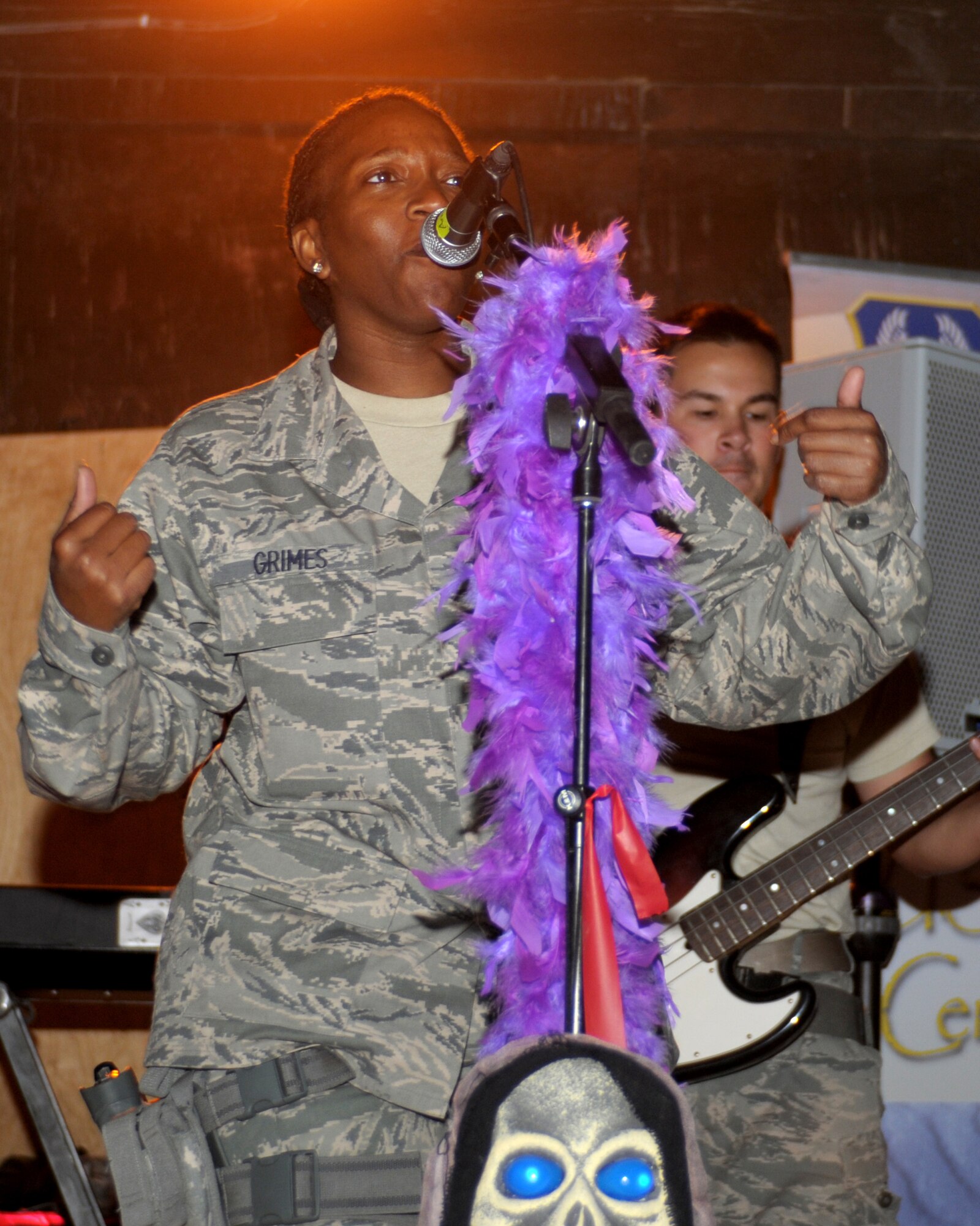 Tech. Sgt. Amber Grimes, lead vocalist for the U.S. Air Forces Central Band, “Top Cover,” sings during a performance Oct. 31, 2011. Top Cover is deployed from Joint Base Elmendorf-Richardson, Alaska. (U.S. Air Force photo/ Senior Airman Krista Rose)