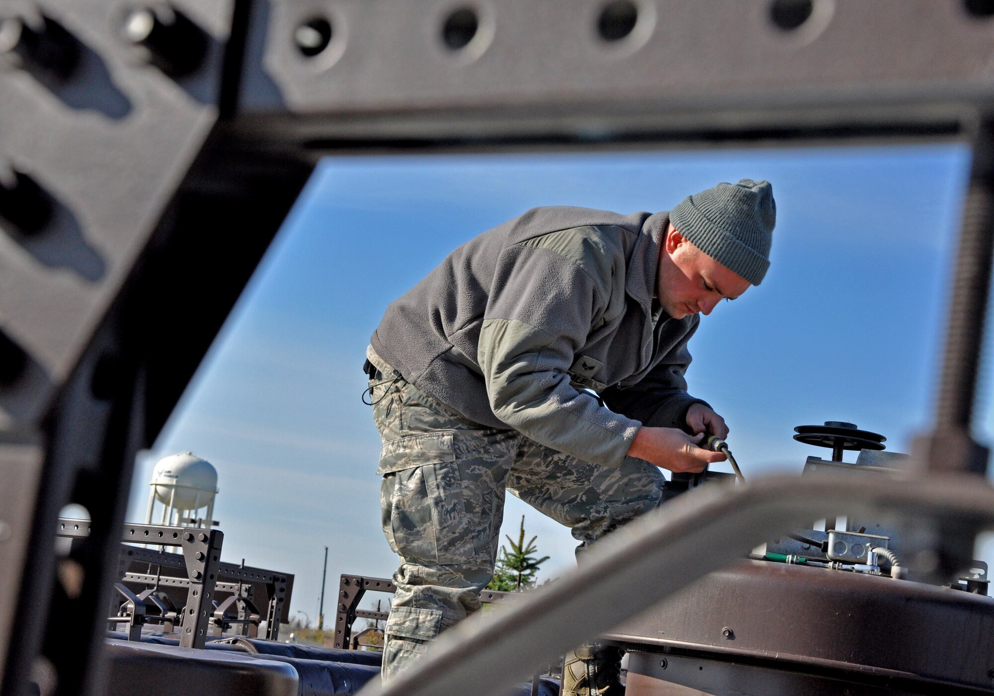 Senior Airman Casey Dale, 319th Civil Engineer Squadron, works on the roof of the 319th Air Base Wing Medical Facility Oct. 21 on Grand Forks Air Force Base, N.D. (U.S. Air Force photo/Airman 1st Class Derek VanHorn)