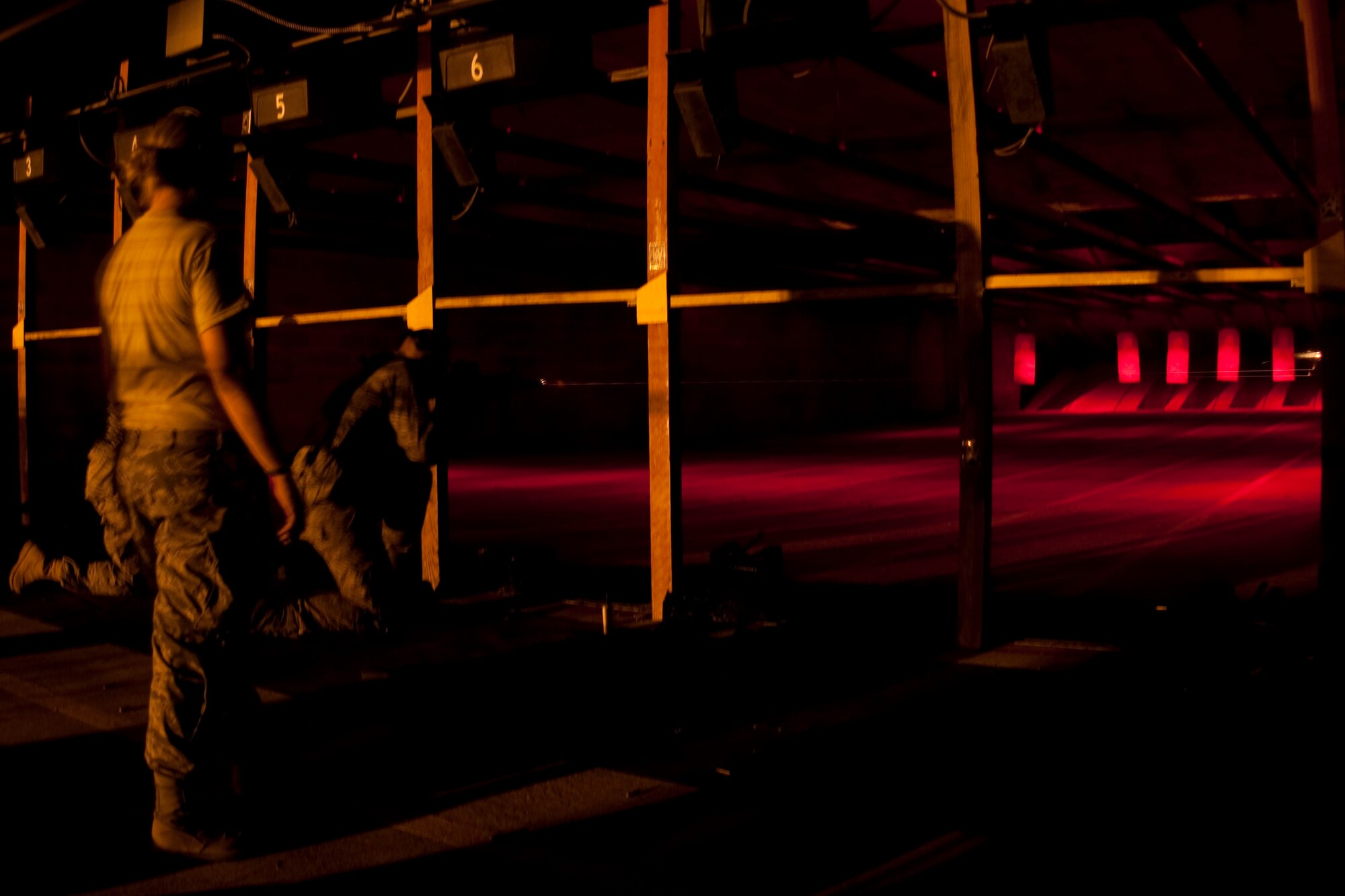 GRISSOM AIR RESERVE BASE, Ind. --  Staff Sgt. Daniel Mann, 434th Security Forces Squadron fire team member, observes as an Airman as he fires his M-4 carbine rifle during a night training exercise here during a recent unit training assembly. (U.S. Air Force photo/Senior Airman Damon Kasberg)