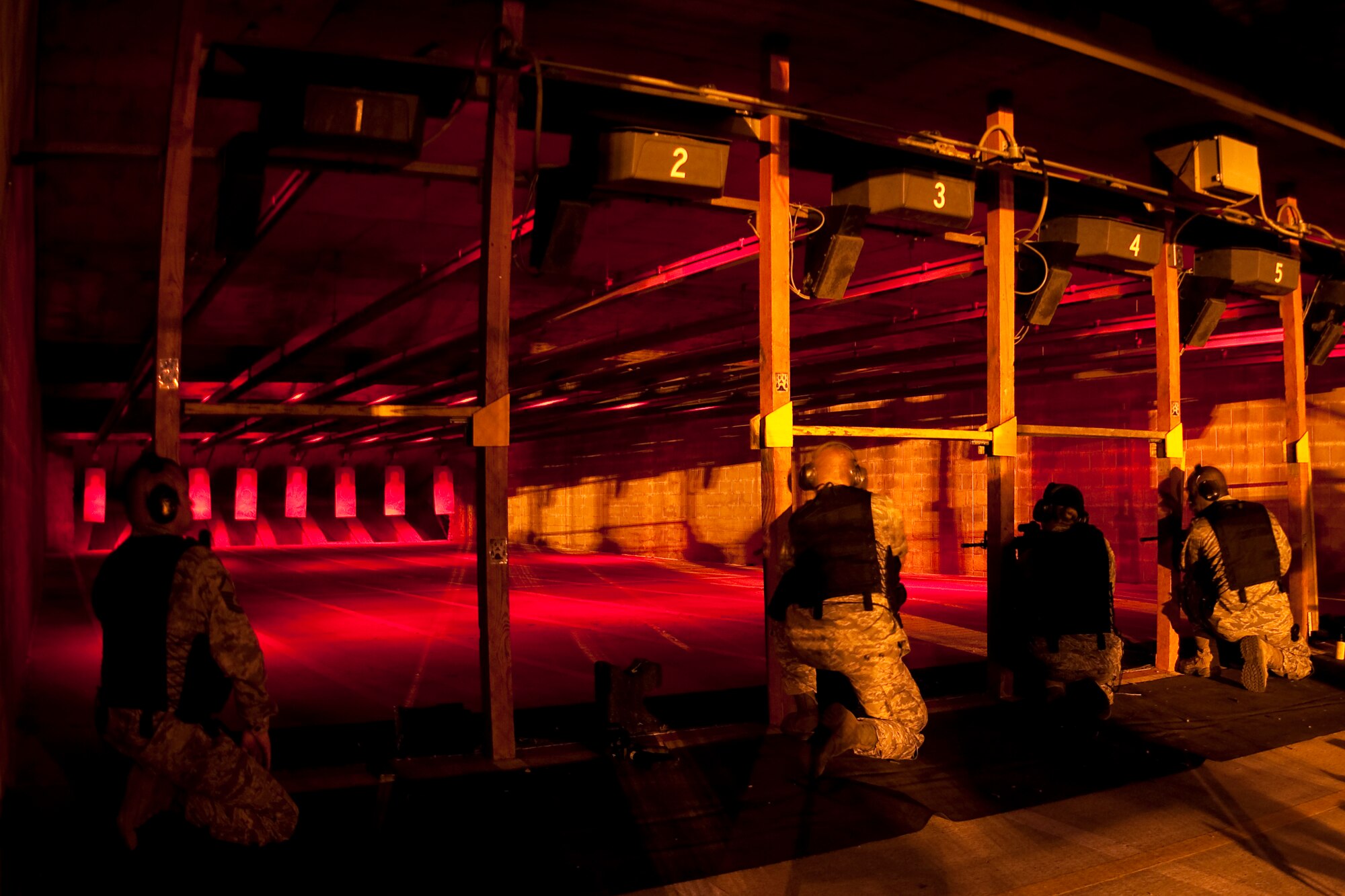 GRISSOM AIR RESERVE BASE, Ind.-- Master Sgt. Christopher Miller, Staff Sgt. Gordon Bell, Senior Airman Christena Al Otaibi and Staff Sgt. Allen Dozier prepare to shoot down range during a night fire training exercise during a recent unit training assembly here. The Airmen shot M-4 carbine rifles in the barricade supported and kneeling supported positions, using both single shot and three round burst, settings on their rifles. All four of the Airmen are a part of the 434th Security Forces Squadron and maintain their readiness throughout the year.   (U.S. Air Force photo/Senior Airman Damon Kasberg)