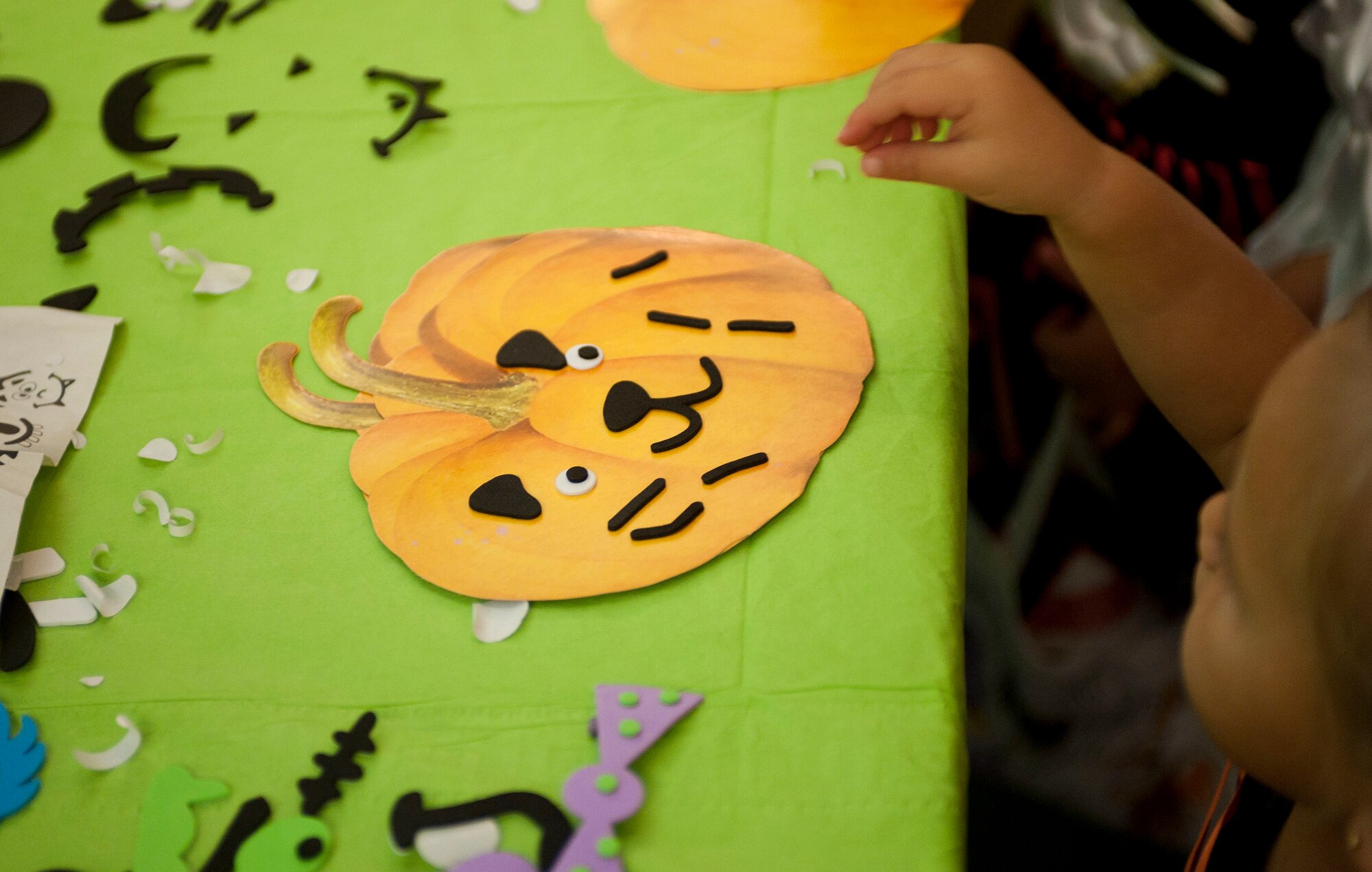 A child decorates a pumpkin during the Children's Halloween Party Oct. 31, 2011, at the Community Center, Incirlik Air Base, Turkey. The party included games, treats and Halloween crafts. (U.S. Air Force photo by Senior Airman Clayton Lenhardt/Released)