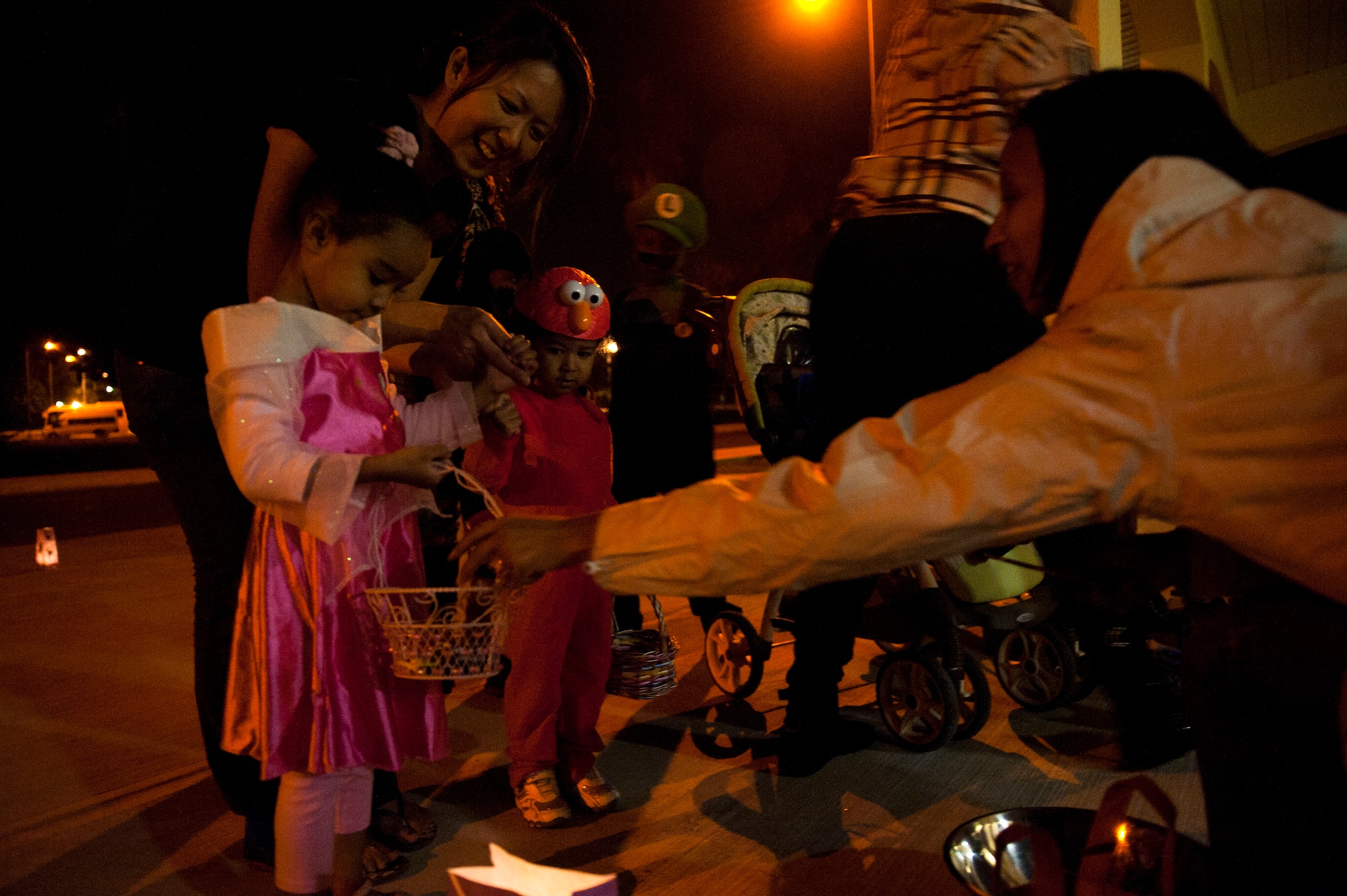 Team Incirlik members participate in trick or treating Oct. 31, 2011, at Incirlik Air Base, Turkey. Base housing was open from 6-8 p.m. for all ages to celebrate Halloween together, dress in costumes and collect treats. (U.S. Air Force photo by Tech. Sgt. Michael B. Keller/Released)