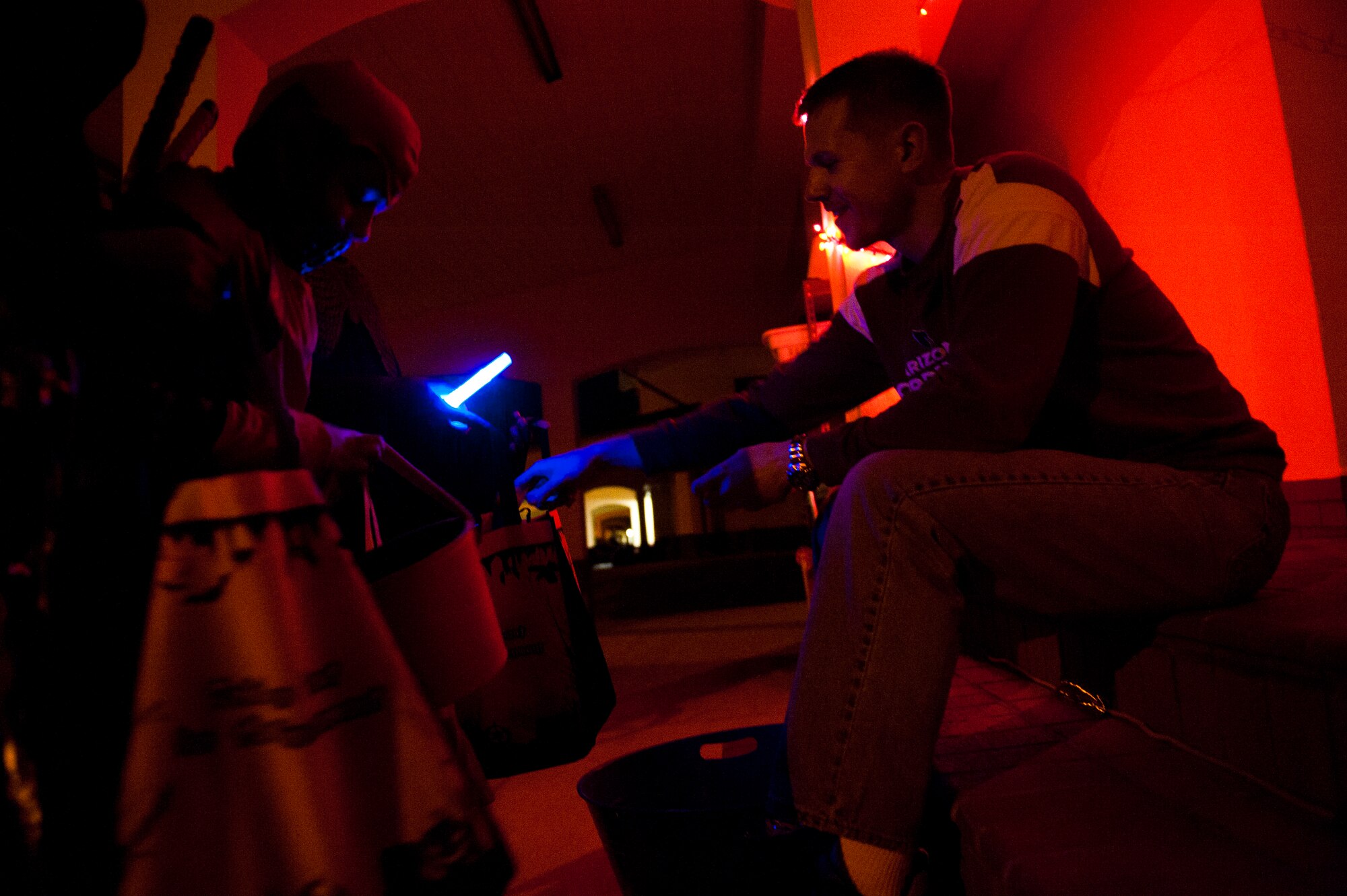 Jason Clute, 39th Force Support Squadron, hands out candy during trick or treating Oct. 31, 2011, at Incirlik Air Base, Turkey. Base housing was open from 6-8 p.m. for all ages to celebrate Halloween together, dress in costumes and collect treats. (U.S. Air Force photo by Tech. Sgt. Michael B. Keller/Released)