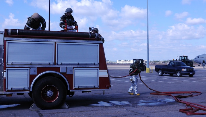 Firefighters from the 628th Civil Engineer Squadron clean up after an exercise scenario during the Operational Readiness Exercise at the Combat Readiness Training Center in Gulfport, Miss. Oct. 27. The firefighters practiced extinguishing a fire on a C-17 Globemaster III to hone their skills in preparation of an emergency.  The ORE is intended to evaluate Team Charleston's ability to "take the fight to the enemy" and objectively measure mission effectiveness. (U.S. Air Force photo/Senior Airman Ian Hoachlander)
