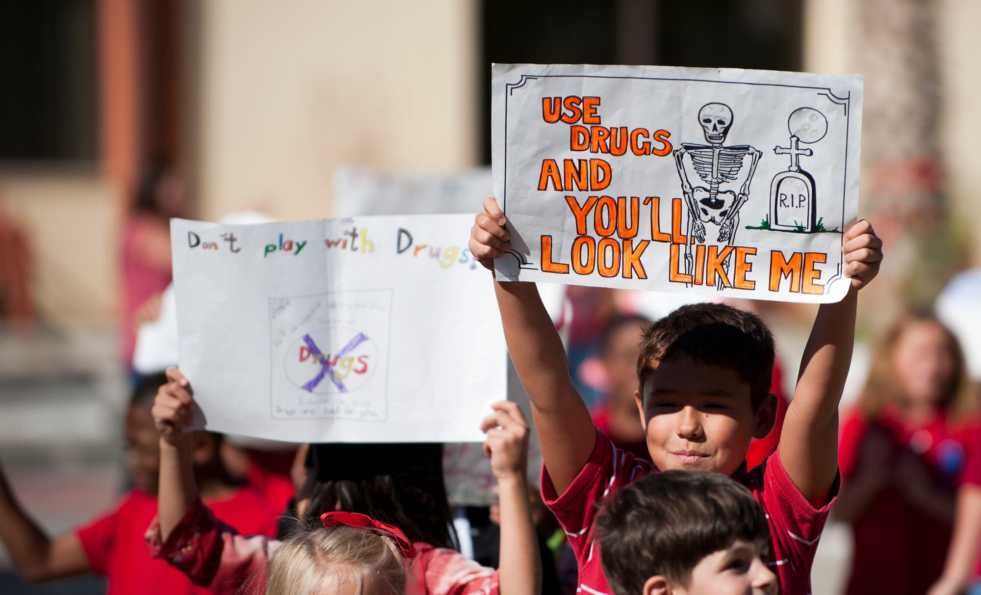 Children and school teachers carry posters and banners during a parade celebrating Red Ribbon Week, Oct. 28, 2011, at Incirlik Air Base, Turkey. Red Ribbon Week is a campaign that promotes drug prevention and education with the ultimate goal of a drug-free America. Red Ribbon Week was celebrated Oct. 23-31 this year. (U.S. Air Force photo by Senior Airman Clayton Lenhardt/Released)