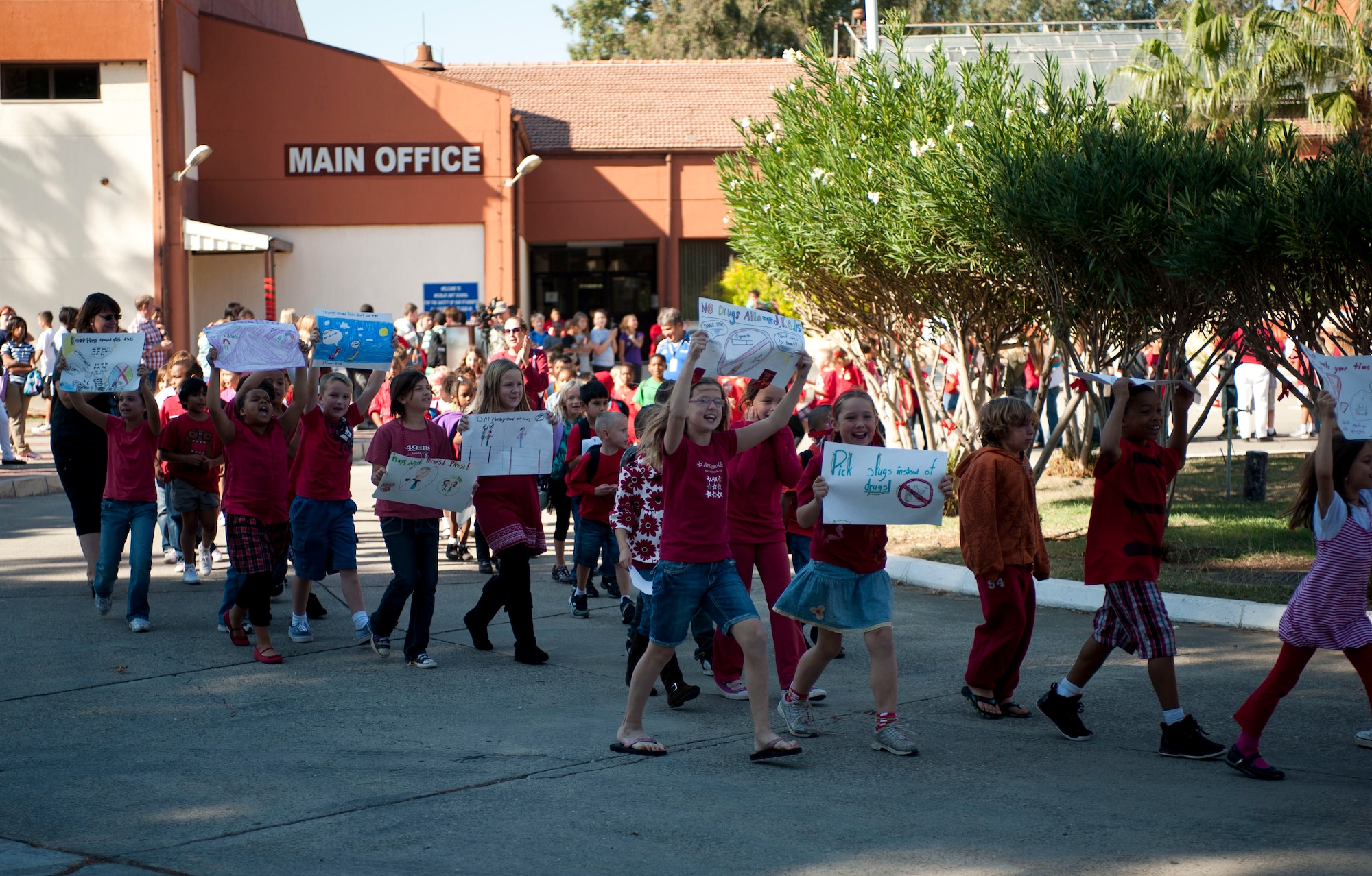 Children and school teachers carry posters and banners during a parade celebrating Red Ribbon Week, Oct. 28, 2011, at Incirlik Air Base, Turkey. Red Ribbon Week is a campaign that promotes drug prevention and education with the ultimate goal of a drug-free America. Red Ribbon Week was celebrated Oct. 23-31 this year. (U.S. Air Force photo by Senior Airman Clayton Lenhardt/Released)