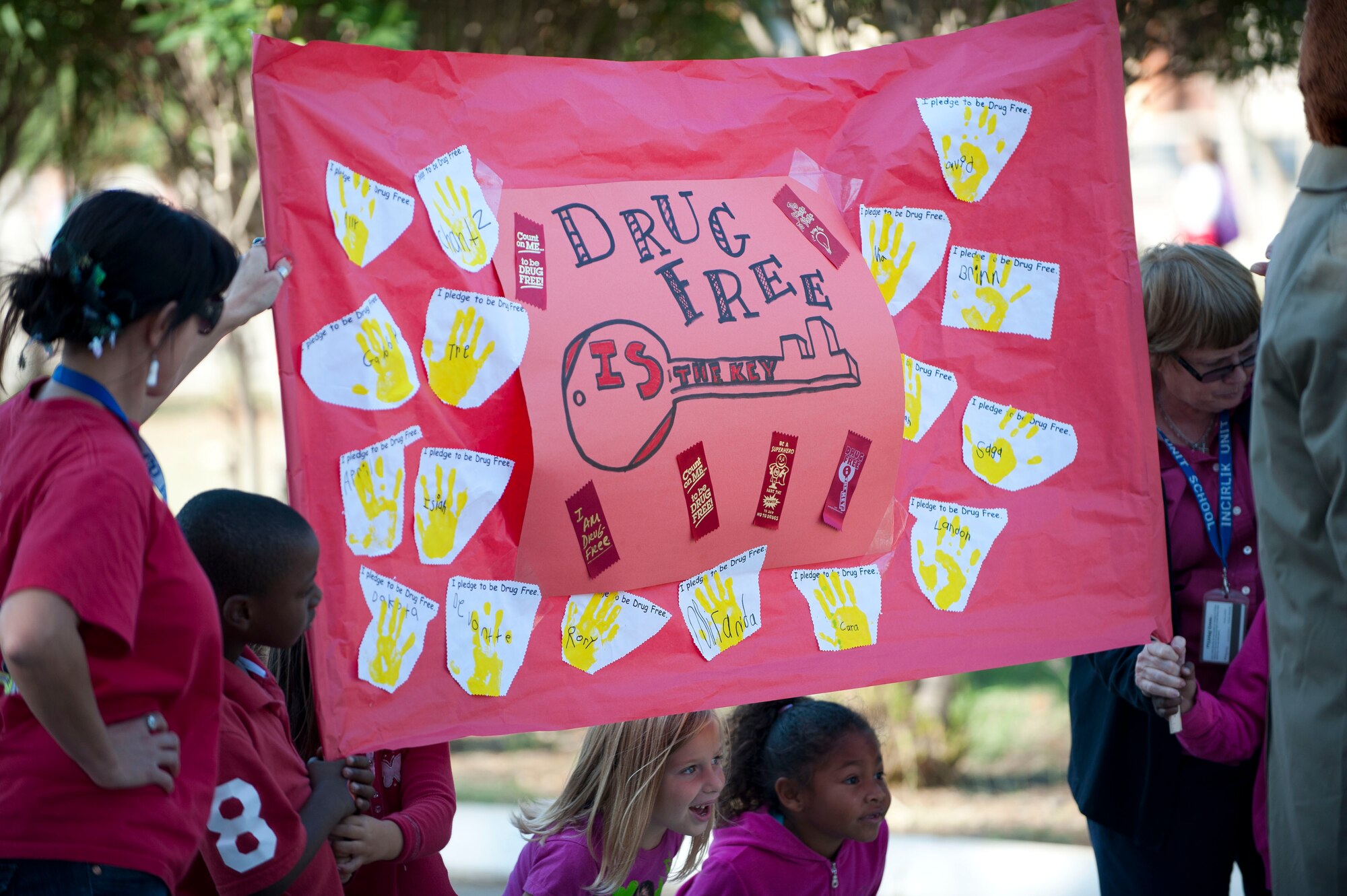 Children and school teachers carry posters and banners during a parade celebrating Red Ribbon Week, Oct. 28, 2011, at Incirlik Air Base, Turkey. Red Ribbon Week is a campaign that promotes drug prevention and education with the ultimate goal of a drug-free America. Red Ribbon Week was celebrated Oct. 23-31 this year. (U.S. Air Force photo by Senior Airman Clayton Lenhardt/Released)