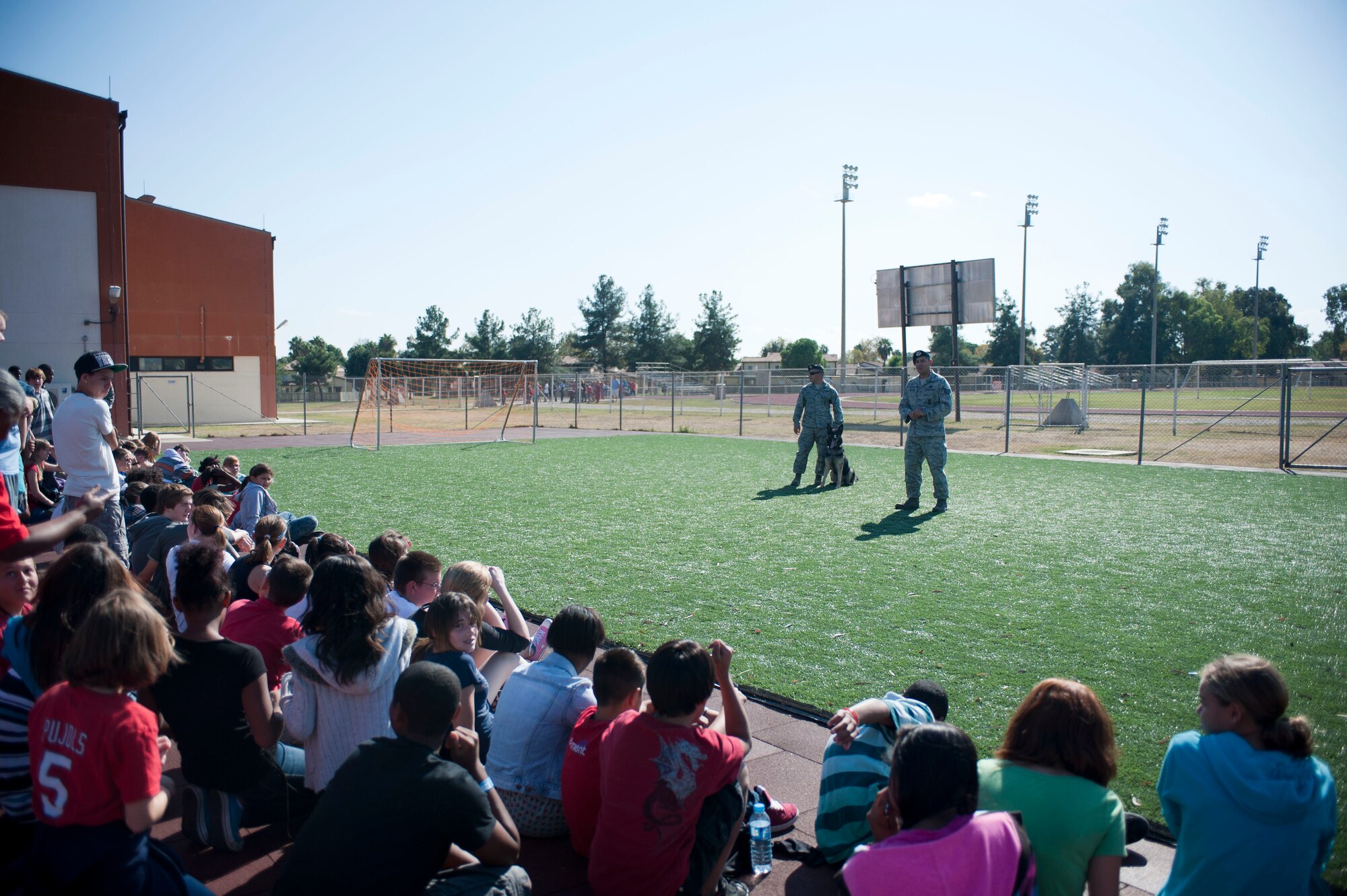Staff Sgt. Juan Garcia and Tech. Sgt. Fred Thiessen, 39th Security Forces Squadron, speak to a group of schoolchildren prior to a parade celebrating Red Ribbon Week, Oct. 28, 2011, at Incirlik Air Base, Turkey. Red Ribbon Week is a campaign that promotes drug prevention and education with the ultimate goal of a drug-free America. Red Ribbon Week was celebrated Oct. 23-31 this year. (U.S. Air Force photo by Senior Airman Clayton Lenhardt/Released)