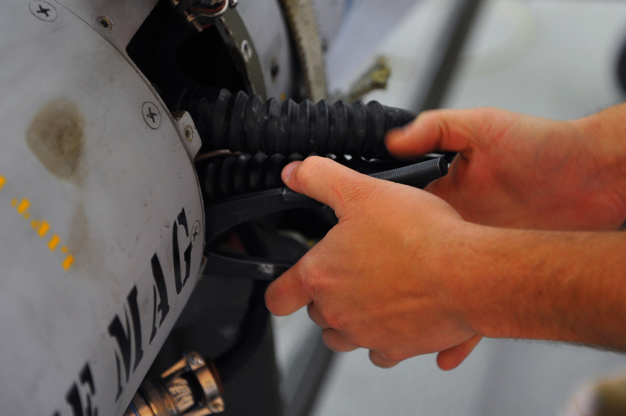 SPANGDAHLEM AIR BASE, Germany – An Airman from the 52nd Equipment Maintenance Squadron removes a cable from the TV guidance of a missile during a functions check inside the munitions maintenance shop here Oct. 27. The 52nd Equipment Maintenance Squadron tests every munition on base after 20 flights or after 180 days to guarantee mission surety and provide combat power to U.S. European Command. (U.S. Air Force photo/Airman 1st Class Dillon Davis)