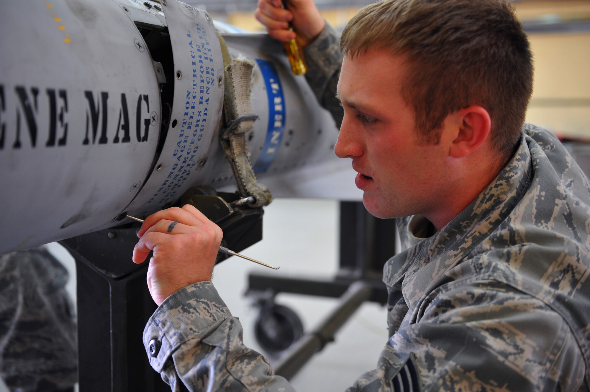 SPANGDAHLEM AIR BASE, Germany – Senior Airman Daniel Chapman, 52nd Equipment Maintenance Squadron precision guided-munitions maintenance crew member, removes the TV guidance access panel before testing the TV guidance system on a missile inside the munitions maintenance shop here Oct. 27. The 52nd Equipment Maintenance Squadron tests every munition on base after 20 flights or after 180 days to guarantee mission surety and provide combat power to U.S. European Command. (U.S. Air Force photo/Airman 1st Class Dillon Davis)