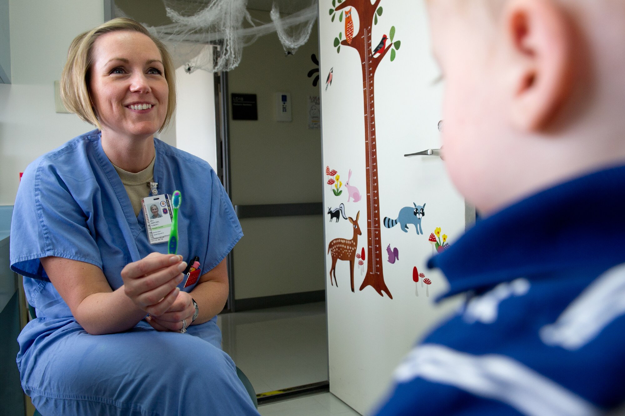 YOKOTA AIR BASE, Japan -- Maj. Stacey Zaikoski, 374th dental Squadron pediatric dentist, gives a briefing of what to expect during a child's first dental visit at Yokota's dental clinic, Oct. 28, 2011. Zaikoski said that the earlier the dental visit, the better the chance of preventing dental problems. (U.S. Air Force photo/Osakabe Yasuo)