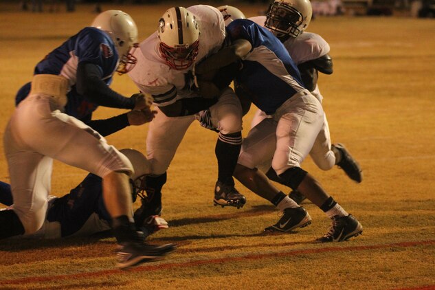MCCES Mustangs’ running back Chris Harris fights to make it to the end zone during the playoff game at Felix Field Nov. 2, 2011.