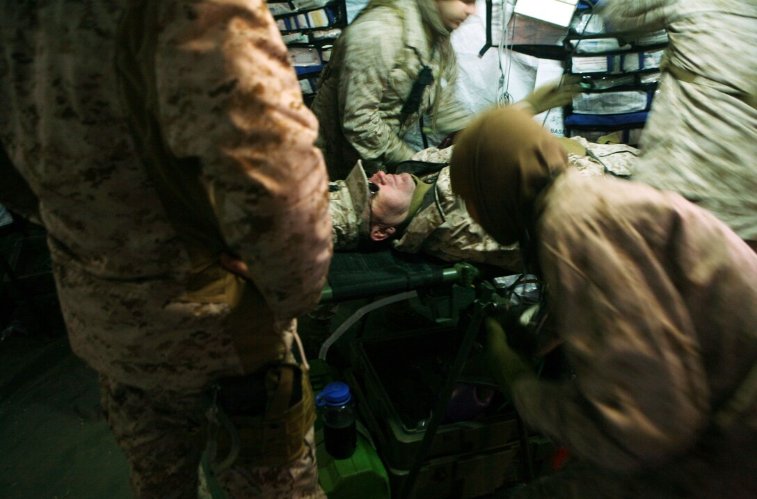 Sailors with 2nd Medical Battalion, Combat Logistics Regiment 25, 2nd Marine Logistics Group tend to a simulated casualty during a field exercise at Landing Zone Lark aboard Camp Lejeune, N.C., Nov. 2, 2011. The five-day exercise included patrols, simulated improvised explosive device training, ambushes by insurgents and treating wounded patients for an array of injuries. (U.S. Marine Corps photo by Pfc. Franklin E. Mercado)