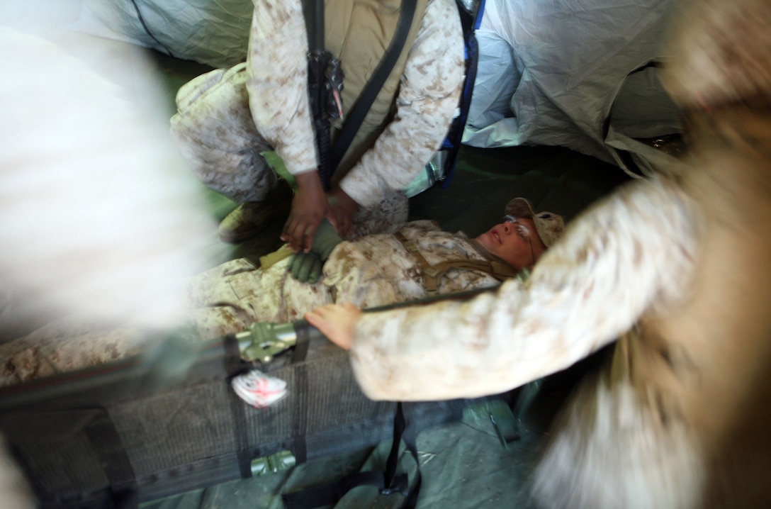 Sailors with 2nd Medical Battalion, Combat Logistics Regiment 25, 2nd Marine Logistics Group search a simulated casualty for weapons during a field exercise at Landing Zone Lark aboard Camp Lejeune, N.C., Nov. 2, 2011. The battalion used the five-day exercise to reacquaint itself with a deployed environment. (U.S. Marine Corps photo by. Pfc. Franklin E. Mercado)