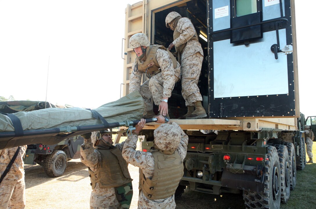 Sailors with 2nd Medical Battalion, Combat Logistics Regiment 25, 2nd Marine Logistics Group dismount a simulated casualty from their Mobile Trauma Bay during a field exercise at Landing Zone Lark aboard Camp Lejeune, N.C., Nov. 2, 2011. The battalion used the five-day exercise to reacquaint itself with a deployed environment. (U.S. Marine Corps photo by. Pfc. Franklin E. Mercado)