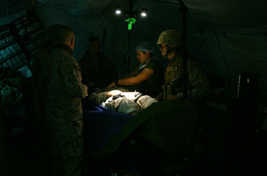 Sailors with 2nd Medical Battalion, Combat Logistics Regiment 25, 2nd Marine Logistics Group perform surgery on a simulated patiend during a field exercise at Landing Zone Lark aboard Camp Lejeune, N.C., Nov. 2, 2011. The five-day exercise included patrols, simulated improvised explosive device training, ambushes by insurgents and treating wounded patients for an array of injuries. (U.S. Marine Corps photo by. Pfc. Franklin E. Mercado)
