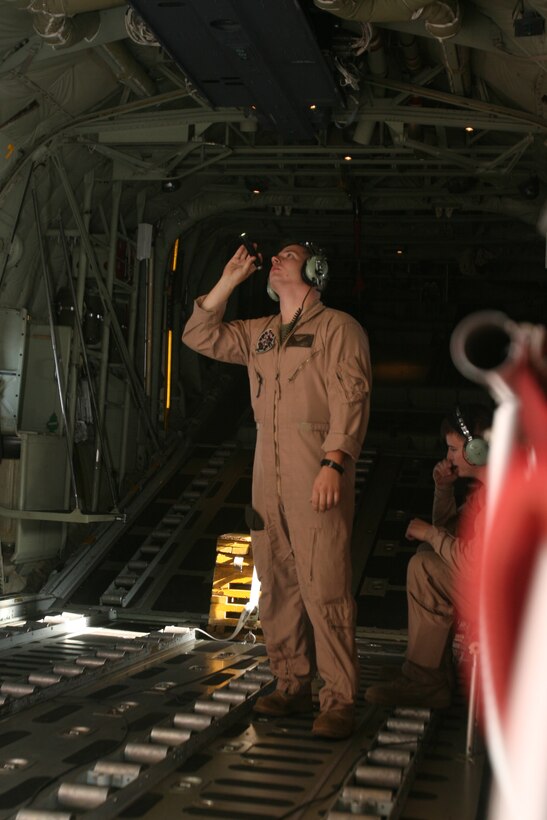 VMGR-252 loadmaster LCpl Blaise Conway inspects the cargo area of a KC-130J before the Cherry Point crew takes off for its destination at Eglin Air Force Base, Fl. to pick up the squadron's new aircraft.