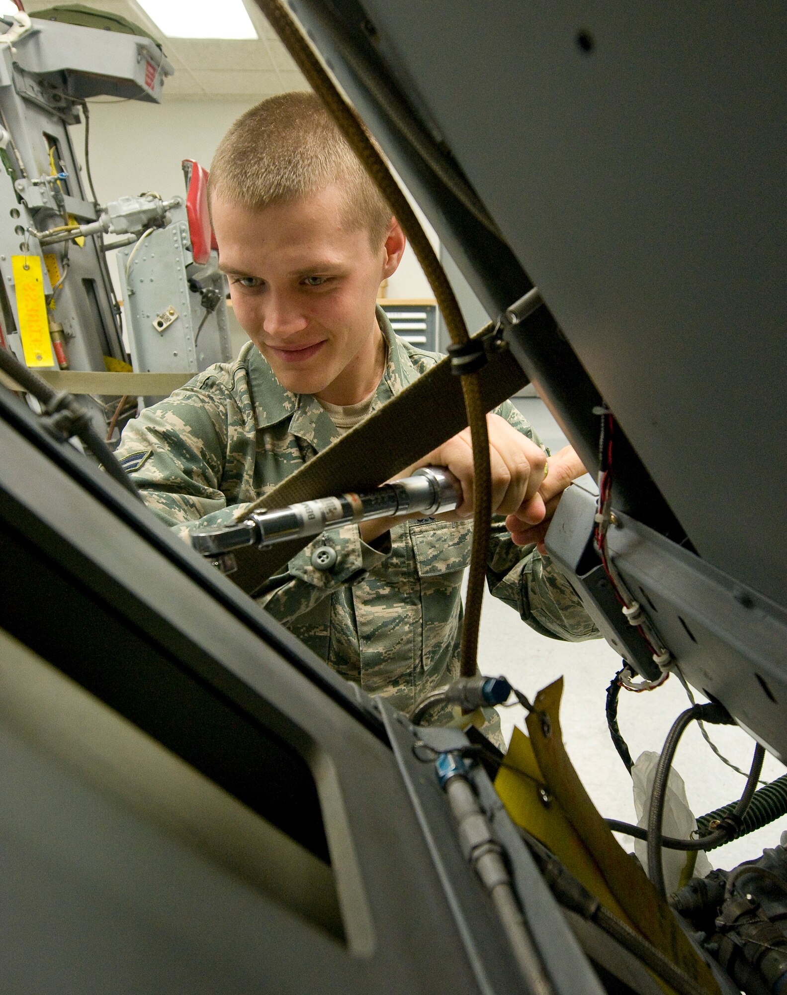 Airman 1st Class Jacob Hedley, 2nd Maintenance Group egress flight, tightens a ballistic line on a B-52H Stratofortress ejection seat on Barksdale Air Force Base, La., Nov. 2. The line carries high pressure gas that operates the seat's ejection mechanism. (U.S. Air Force photo/Senior Airman Chad Warren)(RELEASED)