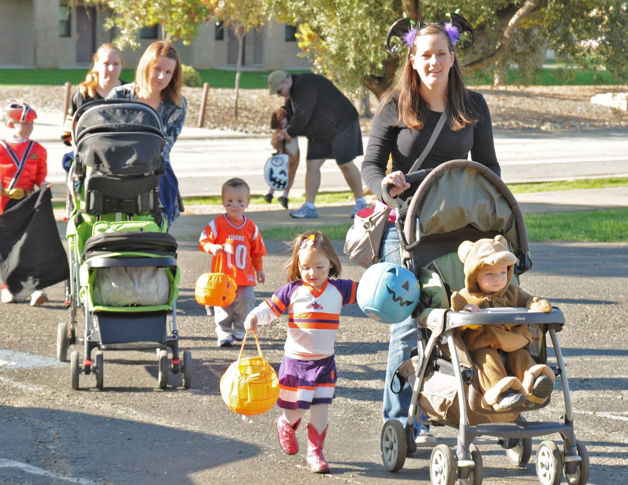 Parents take their kids around Beale Air Force Base during a Halloween parade, which stopped at several main base offices, Oct., 31, 2011. The Community Activity Center designed the activity in order for Beale kids to dress up and receive candy on Halloween. (U.S. Air Force photo by Senior Airman Samantha Krolikowski/ Released)