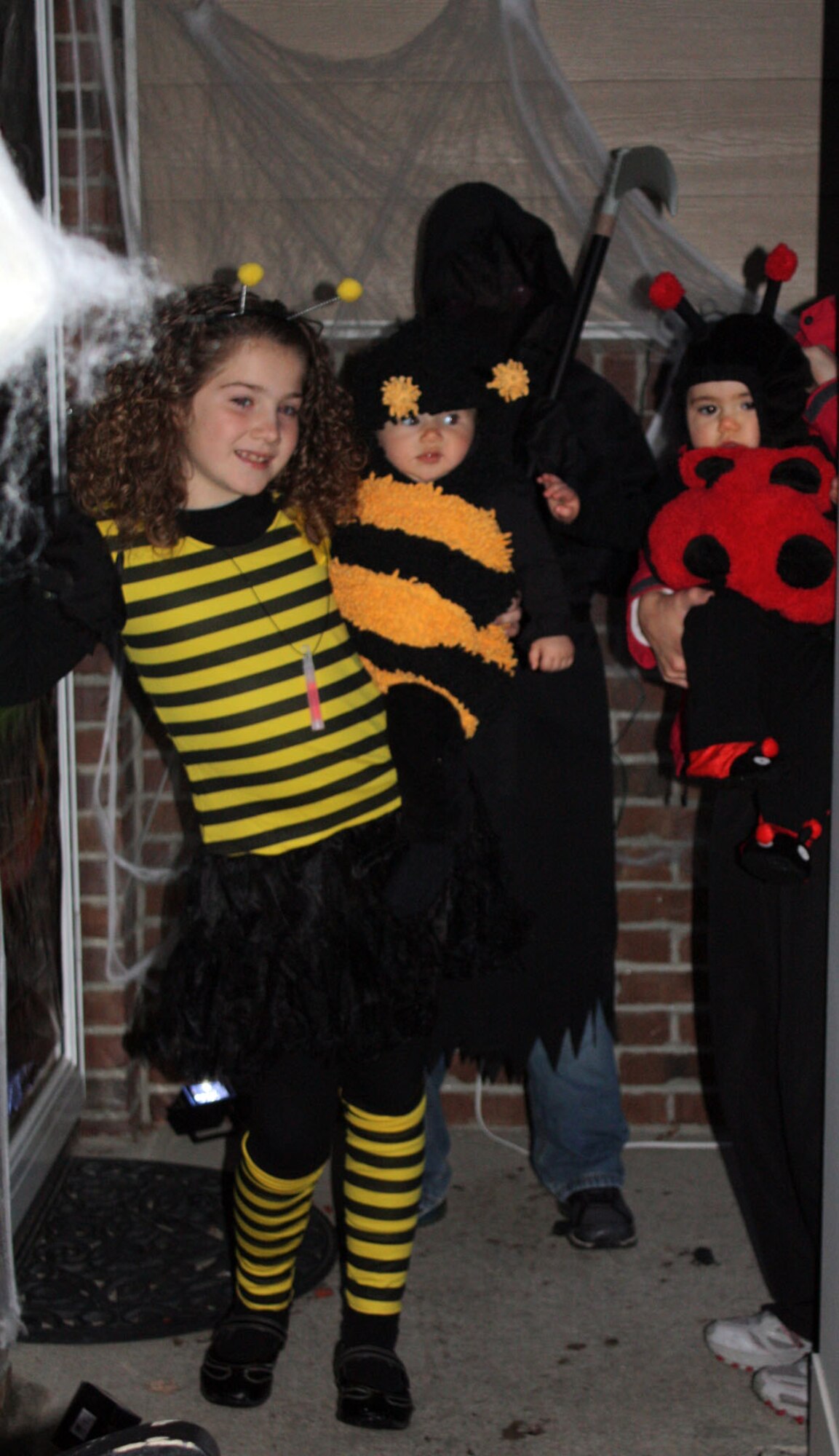 HANSCOM AIR FORCE BASE, Mass. – Ashton, Isla and Zach Carmichael, as well as Chloe Hreben (left to right) knock on a door for some treats during trick or treating Oct. 31. Neighborhood kids were invited to fill up their bags with goodies from 6 to 8 p.m. (U.S. Air Force photo by Sarah Olaciregui)