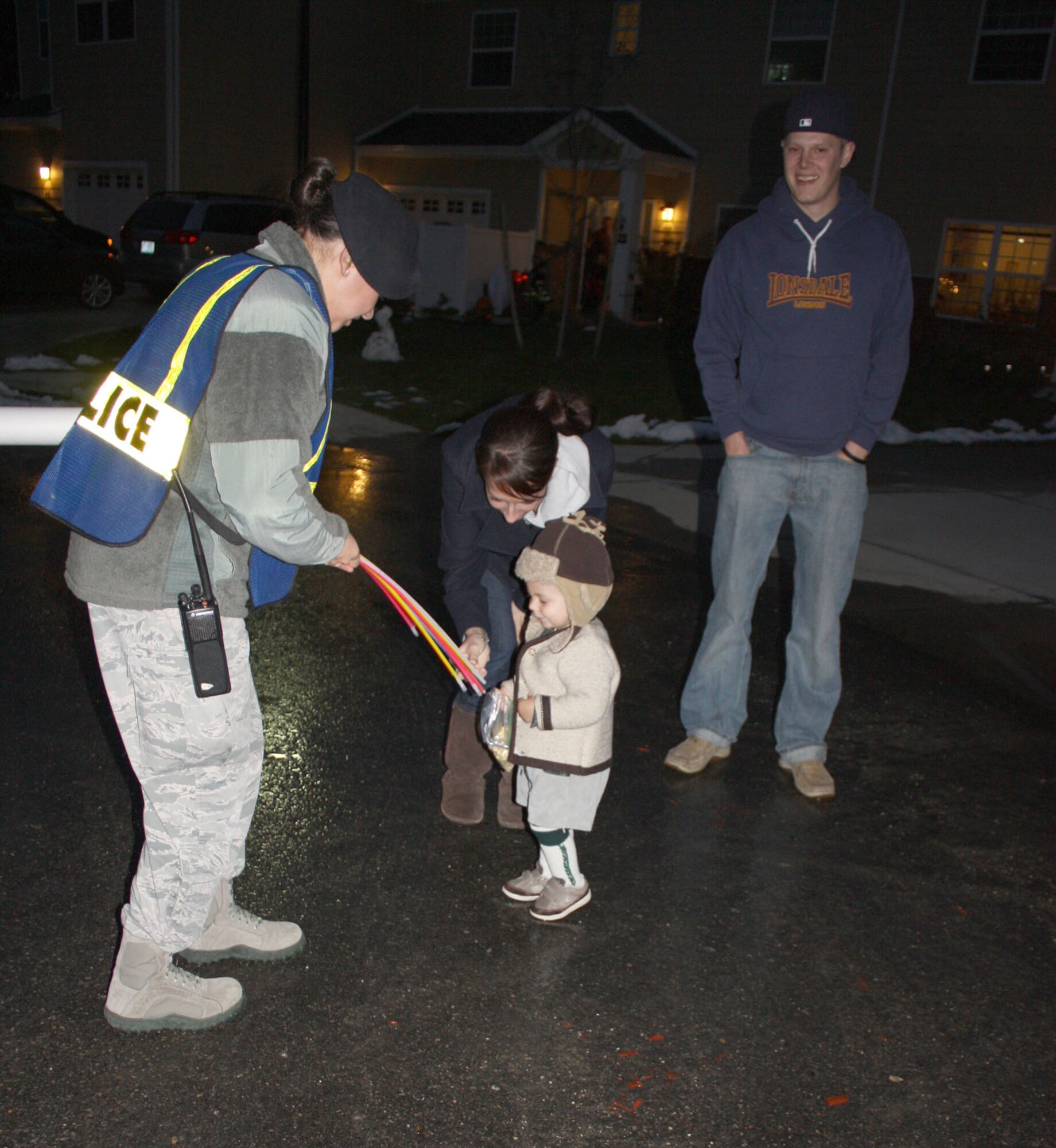 HANSCOM AIR FORCE BASE, Mass. – Benjamin Hofmann-Foster and his mother Jennifer pick out a glow stick from Operation Pumpkin and 66th Security Forces Squadron member Senior Airman Aniza Figueroa during trick or treating Oct. 31. Operation Pumpkin volunteers handed out the glow sticks and ensured a safe night for the young and old alike. (U.S. Air Force photo by Sarah Olaciregui)