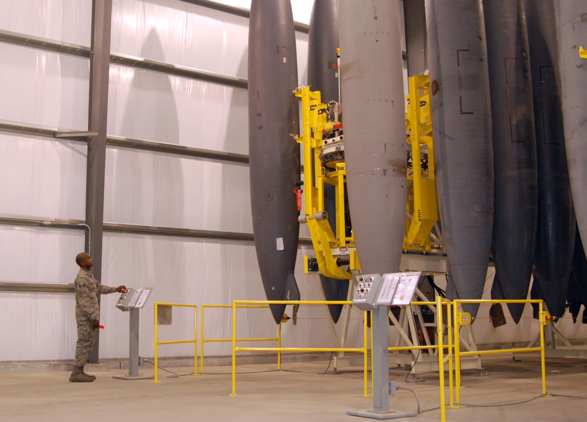 Senior Airman Virgil Campbell, 366th Component Maintenance Squadron aircraft maintenance fuels systems journeyman, lowers an F-15E Strike Eagle external fuel tank using the Vertical Tank Storage System at Mountain Home Air Force Base, Idaho, Oct. 27, 2011. The $2.5 million VTSS stores more than 240 tanks, which were previously stored on a cement pad outside building 1335 here. The new equipment has cut down load and unload time from about an hour to less than five minutes. (U.S. Air Force photo by Senior Airman Alyssa C. Wallace)