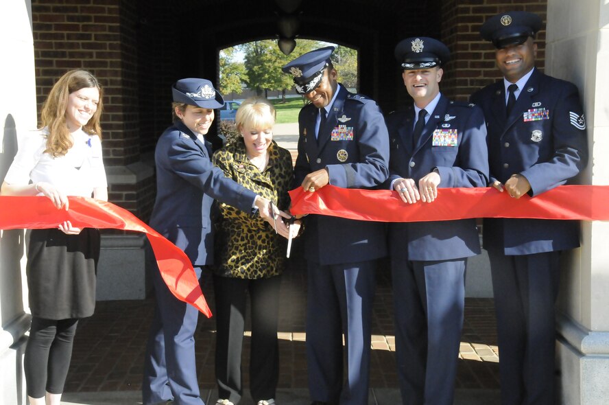From left to right, Emily Urban, Uniformed Services Organization Honor Guard Coordinator, Metropolitan Washington, Col. Gina Humble, 11th Operations Group commander, Elaine Rogers, President, Metropolitan USO, Maj. Gen. Darren W. McDew, Air Force District of Washington commander, Col. Kenneth Rizer, 11th Wing commander and Tech. Sgt. Whitfield Jack, U.S. Air Force Drill Team flight chief, cut the ribbon to the new U.S. Air Force Honor Guard resiliency room at the Honor Guard unit on Joint Base Anacostia-Bolling, Washington, D.C. The project has been in the works since April and was recently completed thanks in great part to funding and support from the USO. (U.S. Air Force photo by Senior Airman Susan L. Davis)