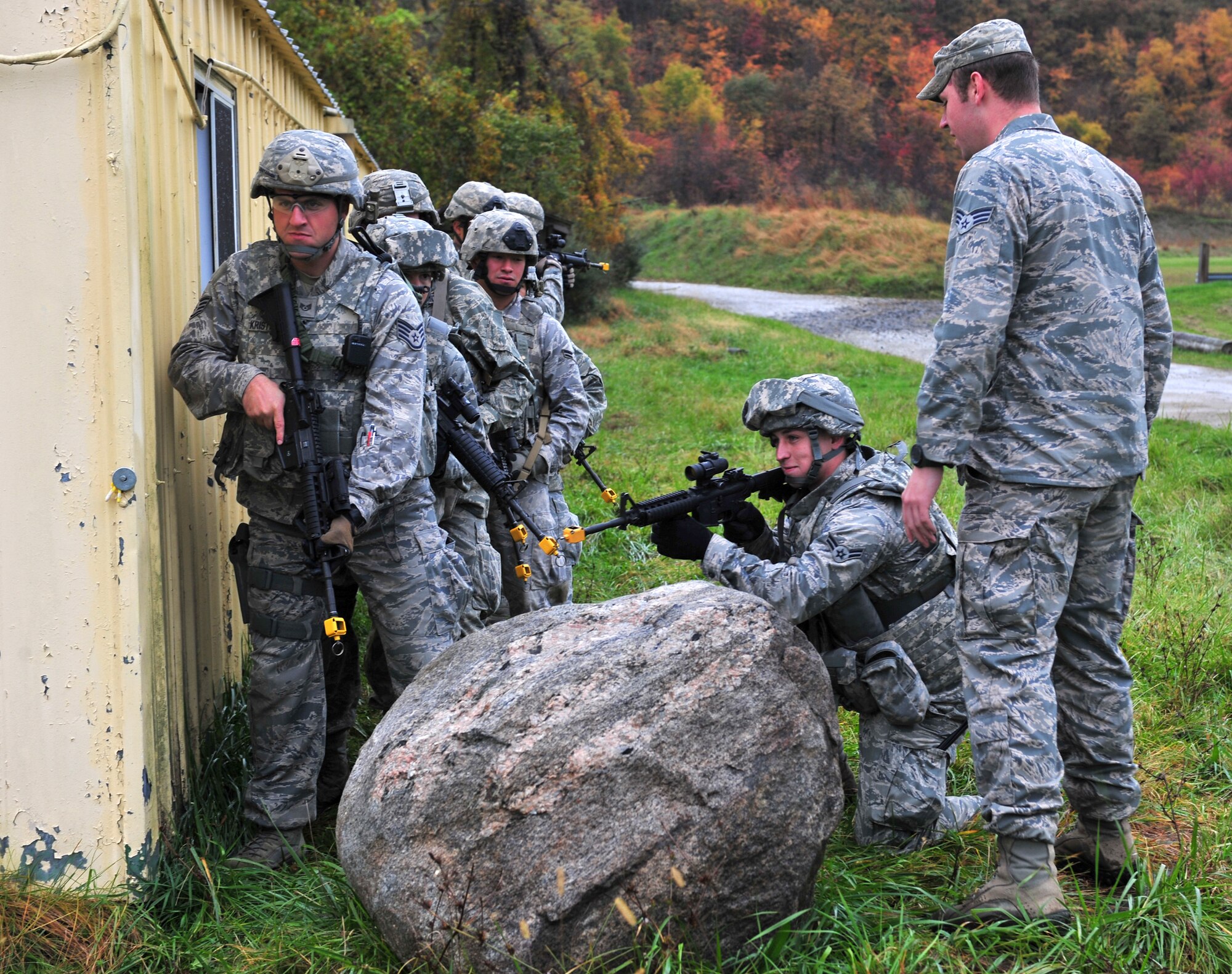 U.S. Air Force Senior Airman Tyler Gann, 823rd Base Defense Squadron unit trainer, evaluates Airmen from the 823rd BDS and 105th Security Forces Squadron on urban operations tactics during joint training at Camp Smith, N.Y., Oct. 27, 2011. Operating with 12 different Air Force specialty codes is routine for the 823rd BDS, but was new to Airmen from the 105th SFS. (U.S. Air Force photo by Staff Sgt. Stephanie Mancha/Released)