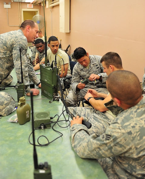 U.S. Air Force Staff Sgt. Daniel Willetts, 823rd Base Defense Squadron client support administrator, trains Airmen from the 823rd BDS and 105th Security Forces Squadron on how to operate a radio during a joint training exercise at Camp Smith, N.Y., Oct. 27, 2011. Willetts set up communication lines for the unit and also trained on how to operate, program and troubleshoot radios, GPS units and blue force trackers. (U.S. Air Force photo by Staff Sgt. Stephanie Mancha/Released)