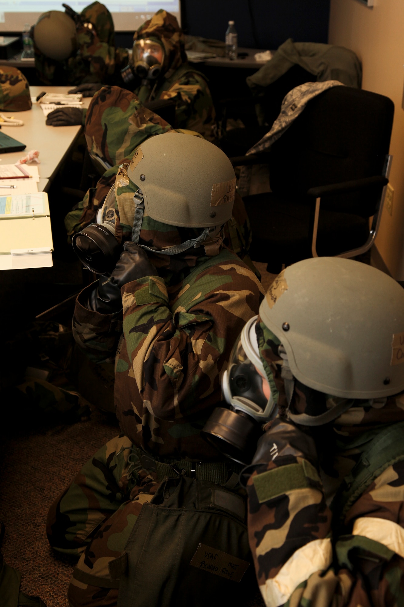 PITTSBURGH IAP ARS, PA -- Members of the 911th Airlift Wings Emergency Operation Center don their Mission Oriented Protection Posture gear during an Attack Response Exercise (ARE), Oct. 2. The EOC flows information from the Installation Control Center to all of the Unit Control Centers on base. (U.S. Air Force photo/Senior Airman Joshua J. Seybert)
