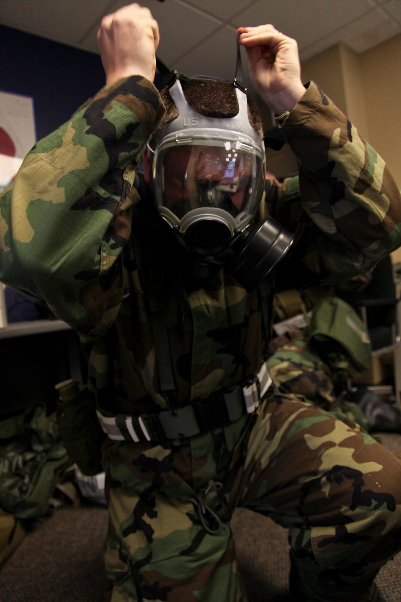 PITTSBURGH IAP ARS, PA -- Lt. Col Ryan, 911th Mission Support Group commander, dons his protective mask during an Attack Response Exercise (ARE), Oct. 2. Airmen of the 911 AW went through various Mission Oriented Protective Posture levels to ensure they knew how to correctly respond to a chemical threat. (U.S. Air Force photo/Senior Airman Joshua J. Seybert)
