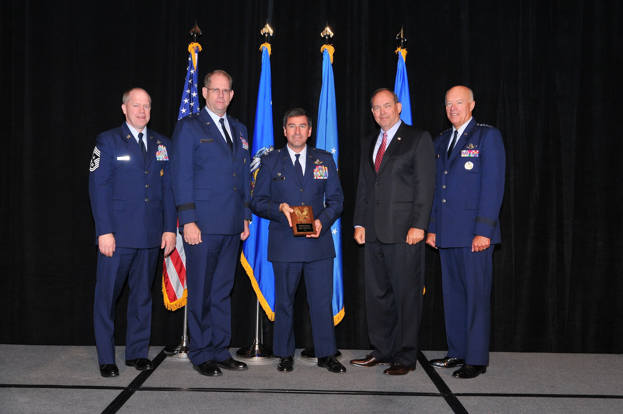 Colonel Peter Nezamis (center), Commander, 126th Air Refueling Wing, accepts the National Guard Association of the U.S. Flying Award on behalf of the Wing. The award is presented annually to the top five Air National Guard flying units that excel in flying safety, aircraft operational readiness, unit manning, skill level qualification and other operational and manning requirements. The Illinois Air National Guard Wing maintains a flying record of more than 29 years with 100,227 flight hours logged. (Courtesy photo)