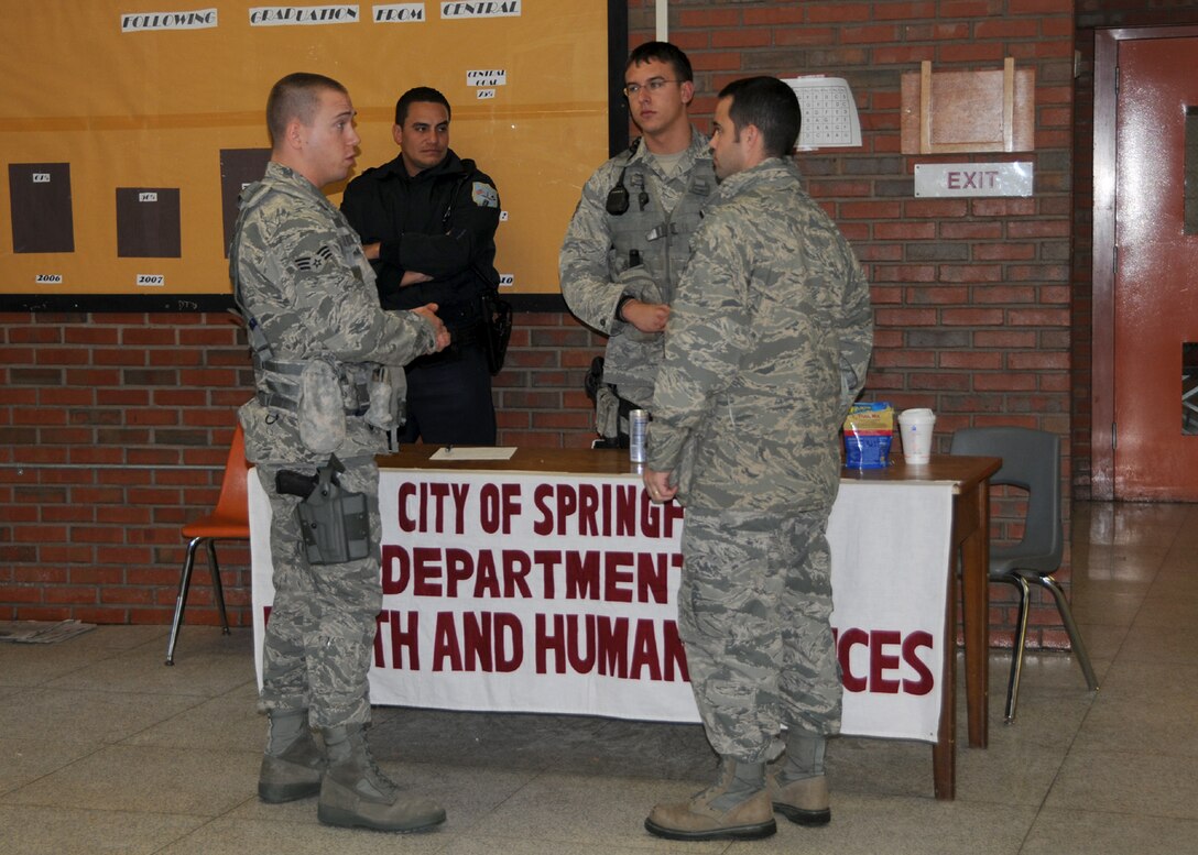 Members of the  104th Fighter Wing Security Forces squadron speak with Major Mathew Mutti about people utilizing the warming-shelter at Springfield Central High School on November 2, 2011. They are providing augmented security following the unusually snow storm that hit the eastern seaboard Oct 29-30th 2011.  (Photograph by TSgt. Melanie J Casineau)