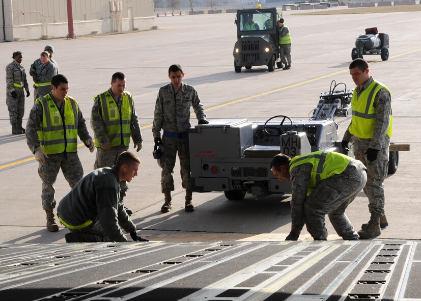 MINOT AIR FORCE BASE, N.D. – Airmen from the 5TH Logistics Readiness Squadron assembled an improvised ramp onto a Boeing C-17 Globemaster III here, Oct. 22. The cargo loaded included this bomb lift truck. Airmen from the 5th LRS, along with others across the base, worked diligently to support Global Thunder 2012. Exercise Global Thunder 12 is U.S. Strategic Command’s annual field training and battle staff exercise, designed to exercise all mission areas with primary emphasis on nuclear command and control. (U.S. Air Force photo/Senior Airman Ashley N. Avecilla)
