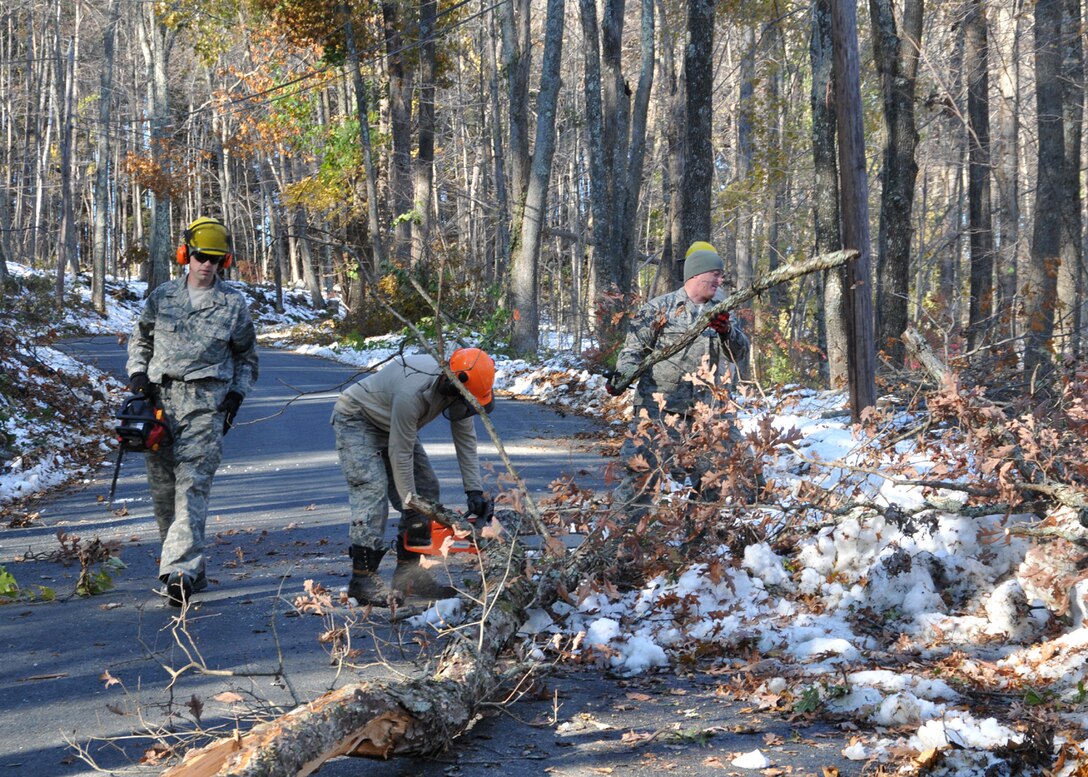 A team of Air National Guard members clear roads in Hampden Mass. following the unusually snow storm that hit the eastern seaboard Oct 29-30th 2011, more than 50 saw-teams were activated to support clean-up efforts throughout Western Massachusetts. (photograph by Maj. Matthew T. Mutti, 104FW/CCE) 