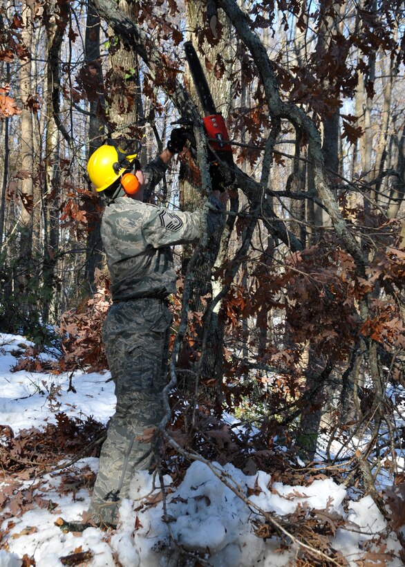 Senior Master Sgt.  Robert Dickinson, a member of the 104th Fighter Wings Logistic Readiness Squadron, in Westfield Mass., cuts down a tree that is blocking a road in Hampden Mass., on Tue, November 1, 2011.  He and more than 50 saw-teams were activated to support clean-up efforts in the state following the unusually snow storm that hit the eastern seaboard Oct 29-30th 2011. (photograph by Maj. Matthew T. Mutti, 104FW/CCE)