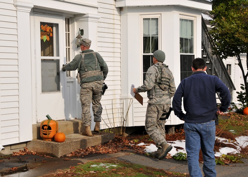 Technical Sgt. Stephen Jeffers and Senior Airman Steven Vignault go door-to-door in Sunderland Mass., checking on residents on the second day of State Operation Harvest Snow in Western Mass.  More than 50 chain saw teams are deployed by the Mass. National Guard to assist in the clean-up following the devastating snow storm Oct 29-30th. (photograph by Maj. Matthew Mutti, 104FW/PA