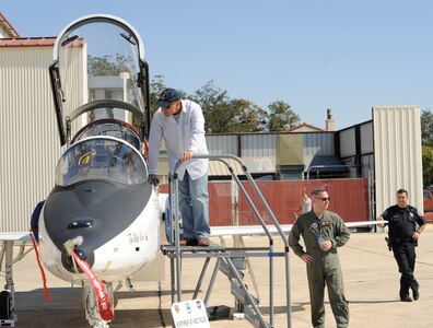 Air show attendee looks in the cockpit of a T-38 Talon at the 2011 Randolph Air Force Base Airshow, Oct. 29. Air shows allow the Air Force to display the capabilities of their aircraft to the American public through aerial demonstrations and static displays. Randolph's air show allows attendees to get up close and personal to see some of the aircraft used by Randolph AFB to train instructor pilots. (U. S. Air Force Photo by Don Lindsey)