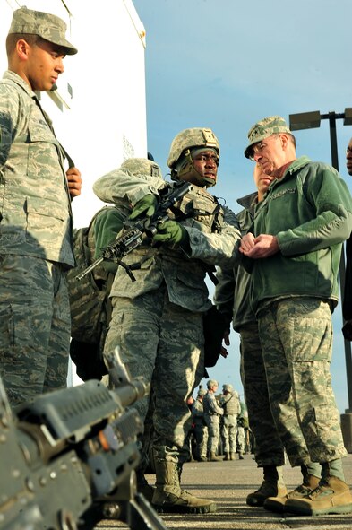MINOT AIR FORCE BASE, N.D. -- Gen. C. Robert Kehler, U.S. Strategic Command commander views the weapon of Airman 1st Class Calvin Robinson, 791st Missile Security Forces Squadron response force team member, during U.S. STRATCOM's annual field training and battle staff exercise here Oct. 20. Kehler made the trip to the base to observe Airmen participating in the exercise at the nation’s only dual-wing nuclear capable base. The exercise provides training opportunities for forces to deter, and if necessary defeat, a military attack against the United States. (U.S. Air Force Photo/Senior Airman Jesse Lopez)