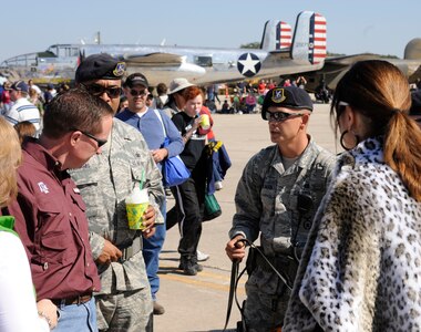 902nd Security Forces Squadron members assist spectators during the 2011 Randolph Air Force Base Airshow Oct. 29. Randolph's air show allowed attendees to get up close and personal to see some of the equipment and aircraft used by the U.S. military servicemembers and Department of Defense civilians today. (U.S. Air Force Photo by Don Lindsey)