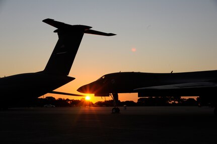 The sun rises over an Air Force B1 Bomber to start off the 2011 Randolph Air Force Base Airshow Oct. 29. Air shows allow the Air Force to display the capabilities of their aircraft to the American public through aerial demonstrations and static displays. (U.S. Air Force Photo by Don Lindsey)