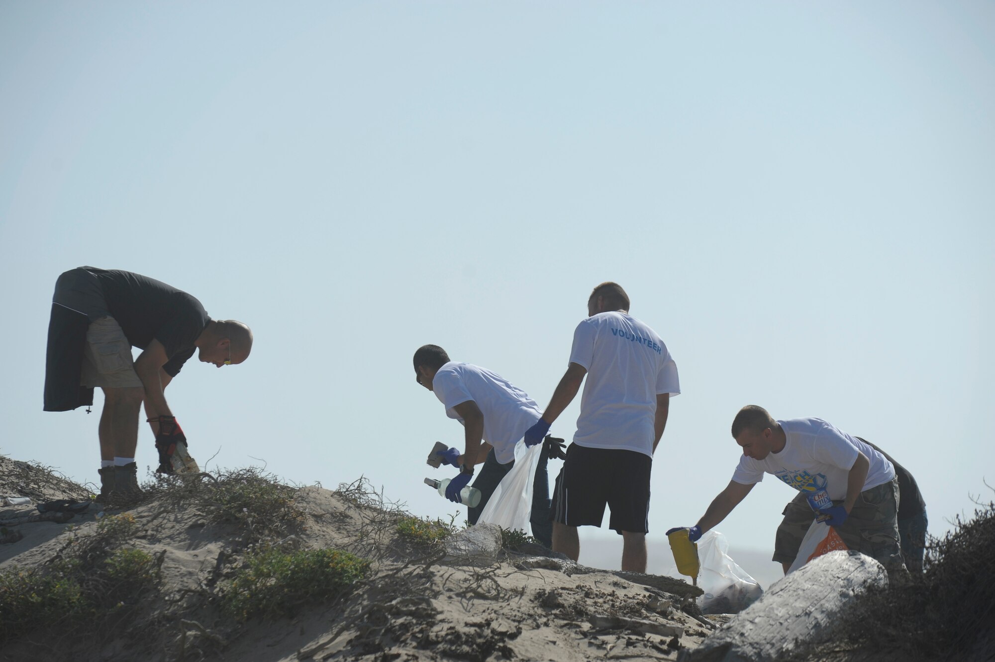 VANDENBERG AIR FORCE BASE, Calif. -- Members of the 30th Civil Engineer Squadron and the 576th Flight Test Squadron pick up trash during the Beach Cleanup Day on base Tuesday, Nov. 1, 2011. The volunteers helped collect more than 2,000 pounds of trash during the event. (U.S. Air Force photo/Staff Sgt. Andrew Satran) 

  
 