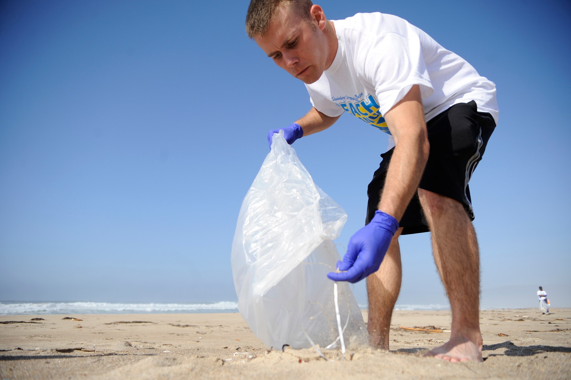 VANDENBERG AIR FORCE BASE, Calif. -- Senior Airman Brian Young, a 30th Civil Engineer Squadron member, picks up trash during the Beach Cleanup Day at Surf Beach on base Tuesday, Nov. 1, 2011. The event was the first base-wide volunteer cleanup for all of the beaches. (U.S. Air Force photo/Staff Sgt. Andrew Satran) 

 